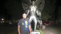 Evan Miller next to Mothman statue.jpg